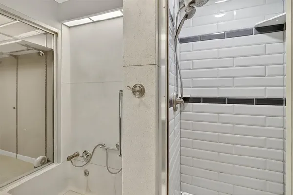 a bathroom with a shower and a sink