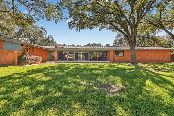 a front view of house with yard and green space