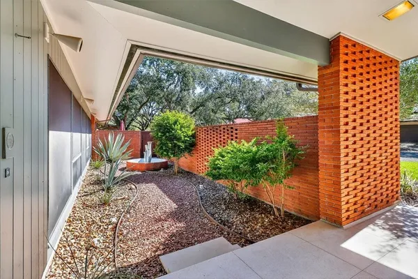 a view of a yard from a corridor