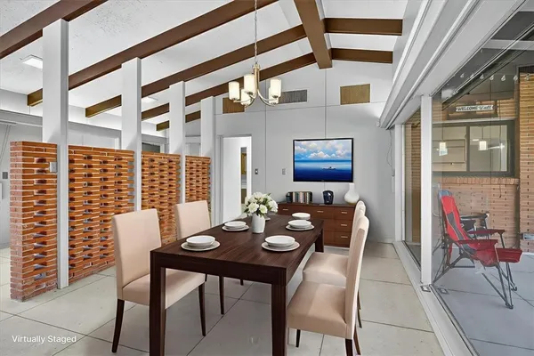 a view of a dining room with furniture and chandelier