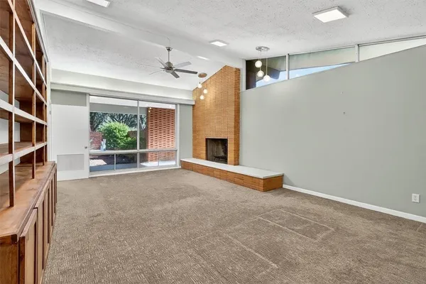 an empty room with furniture and a fireplace