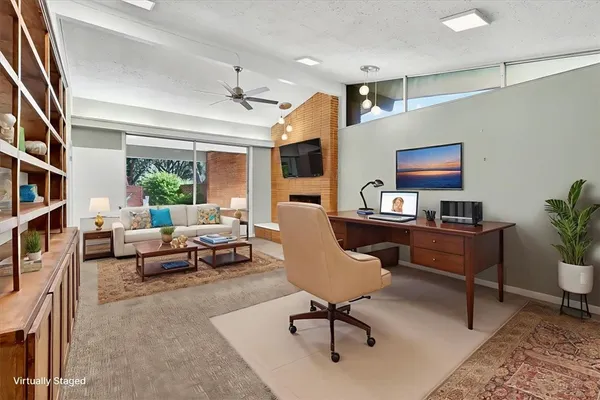 a living room with furniture and a potted plant