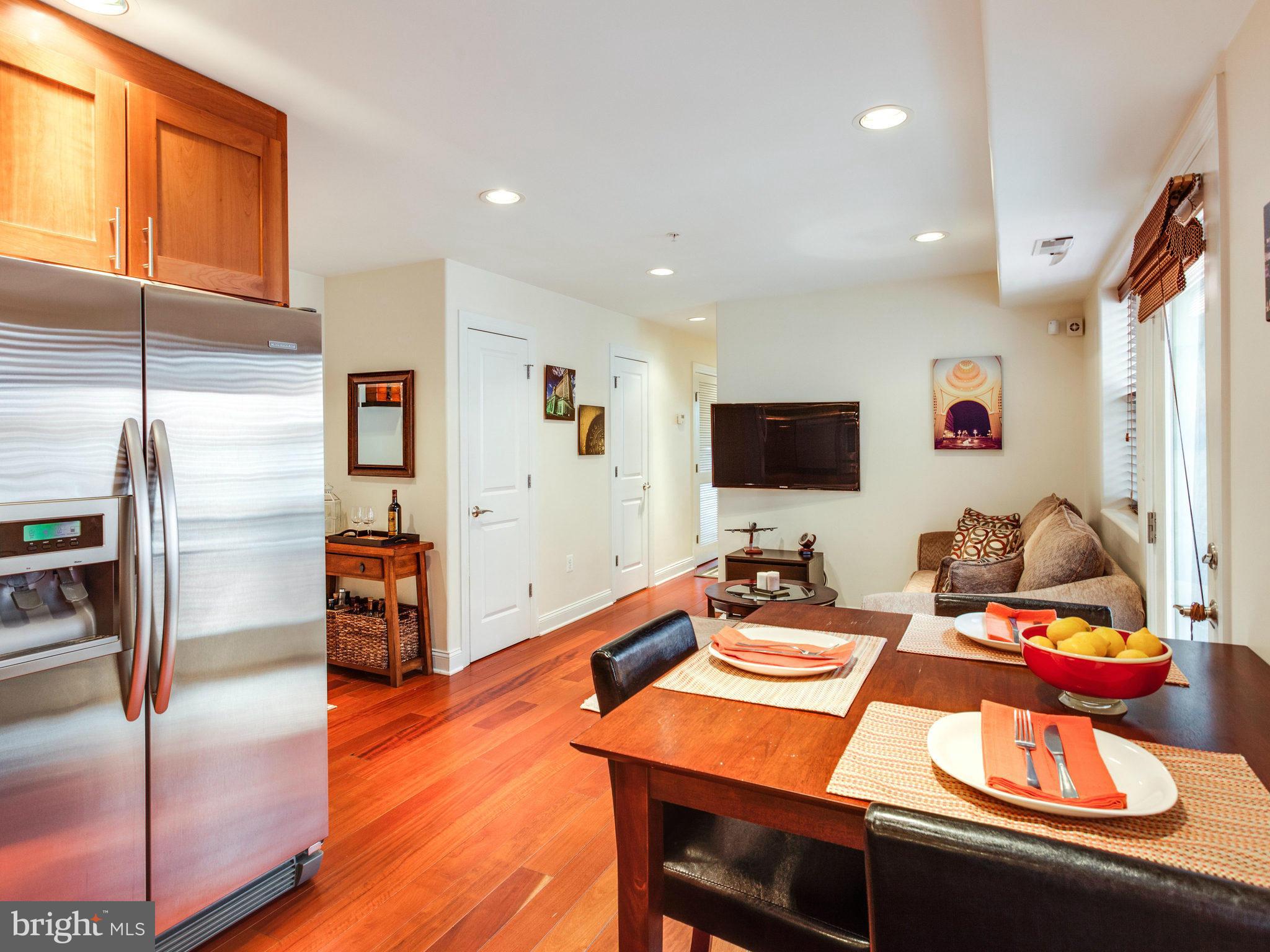 1354 Euclid Street Northwest, Unit B402 Washington, DC 20009 - Photo 11 of 30 a room with furniture and a flat screen tv