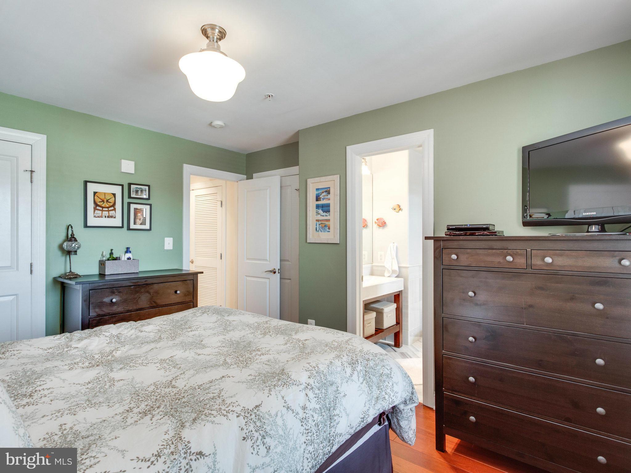 1354 Euclid Street Northwest, Unit B402 Washington, DC 20009 - Photo 13 of 30 a bedroom with a bed and a flat screen tv
