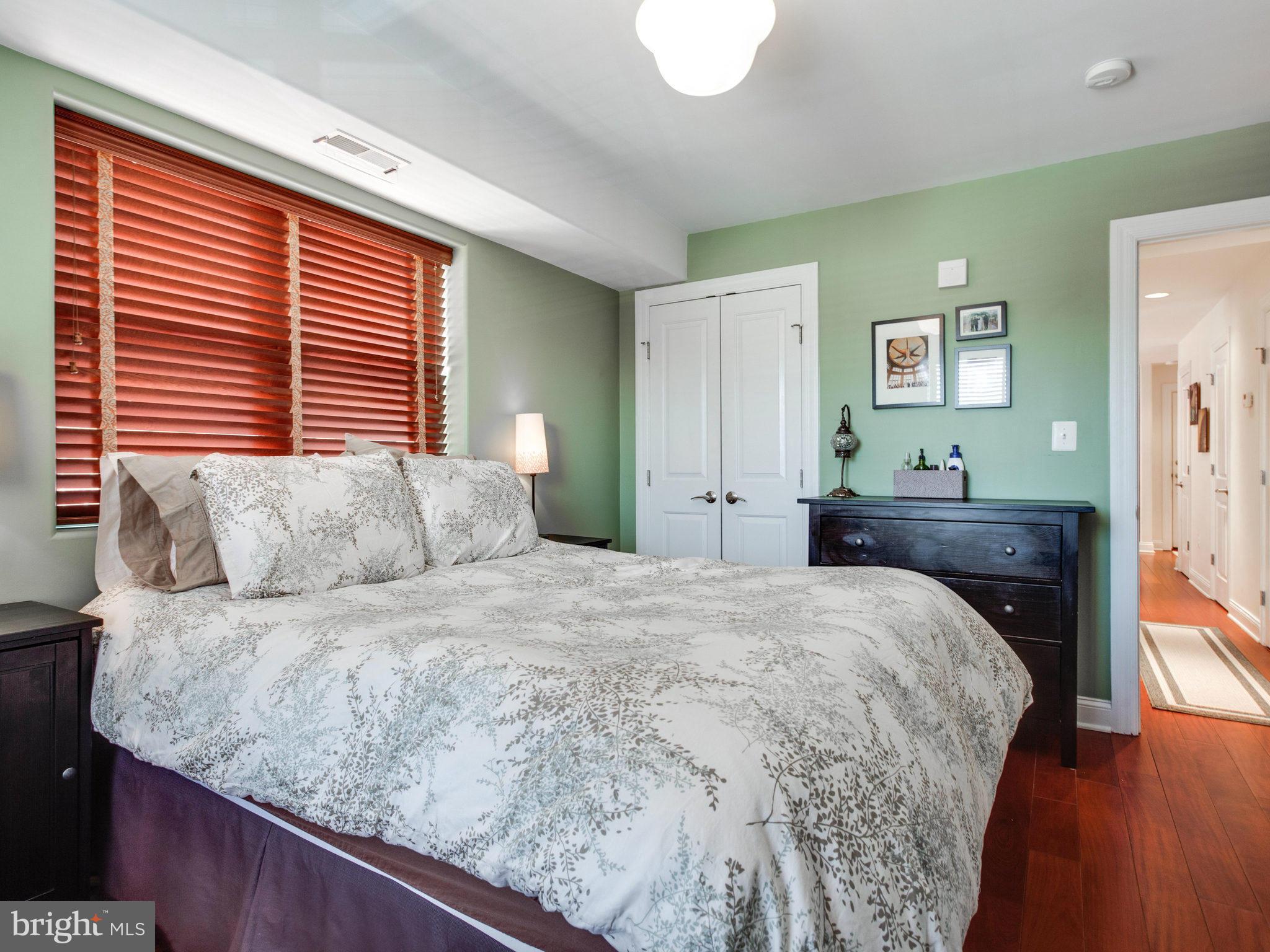 1354 Euclid Street Northwest, Unit B402 Washington, DC 20009 - Photo 14 of 30 a bedroom with a bed and a dresser
