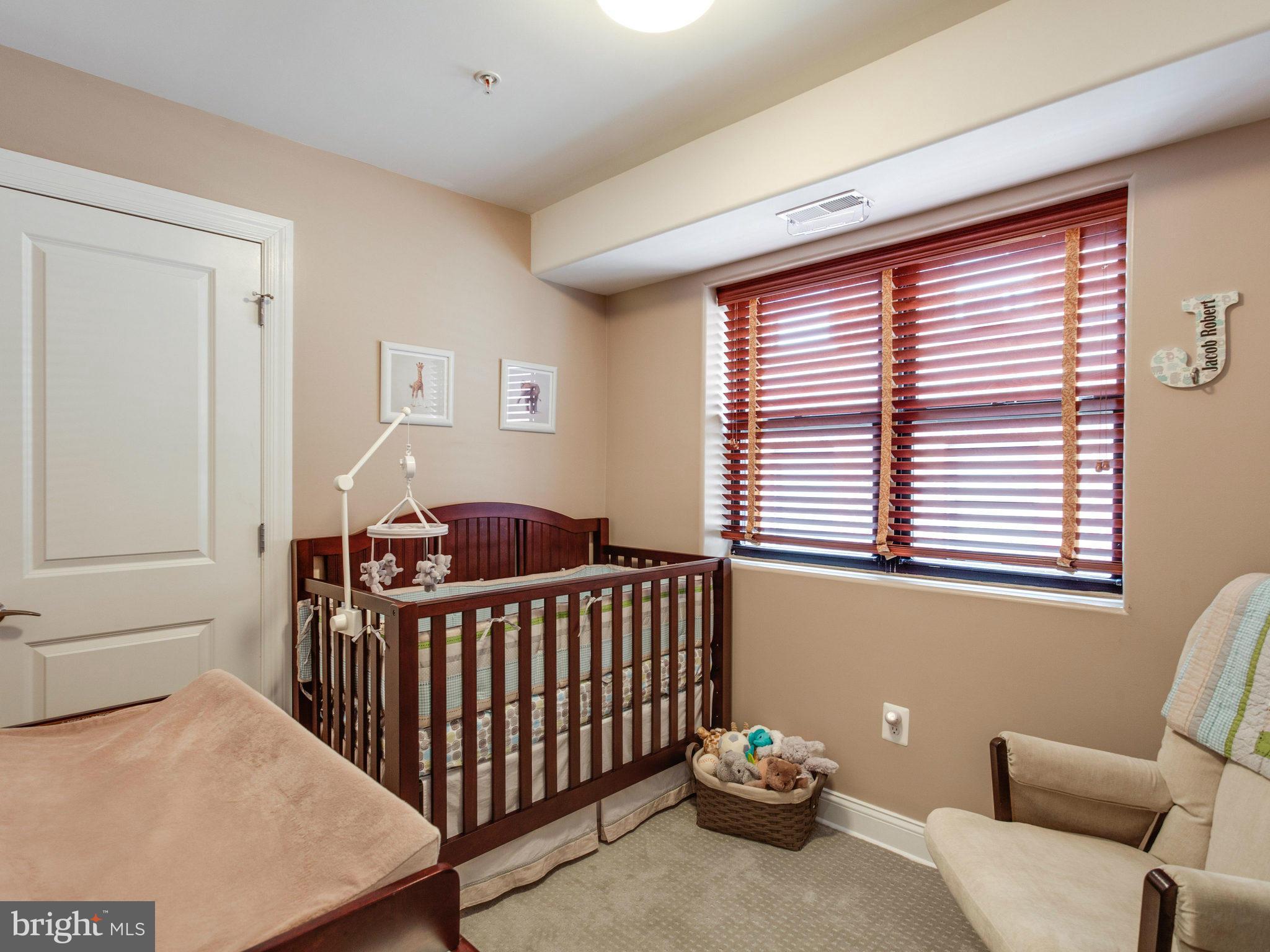 1354 Euclid Street Northwest, Unit B402 Washington, DC 20009 - Photo 17 of 30 a bedroom with furniture and a window