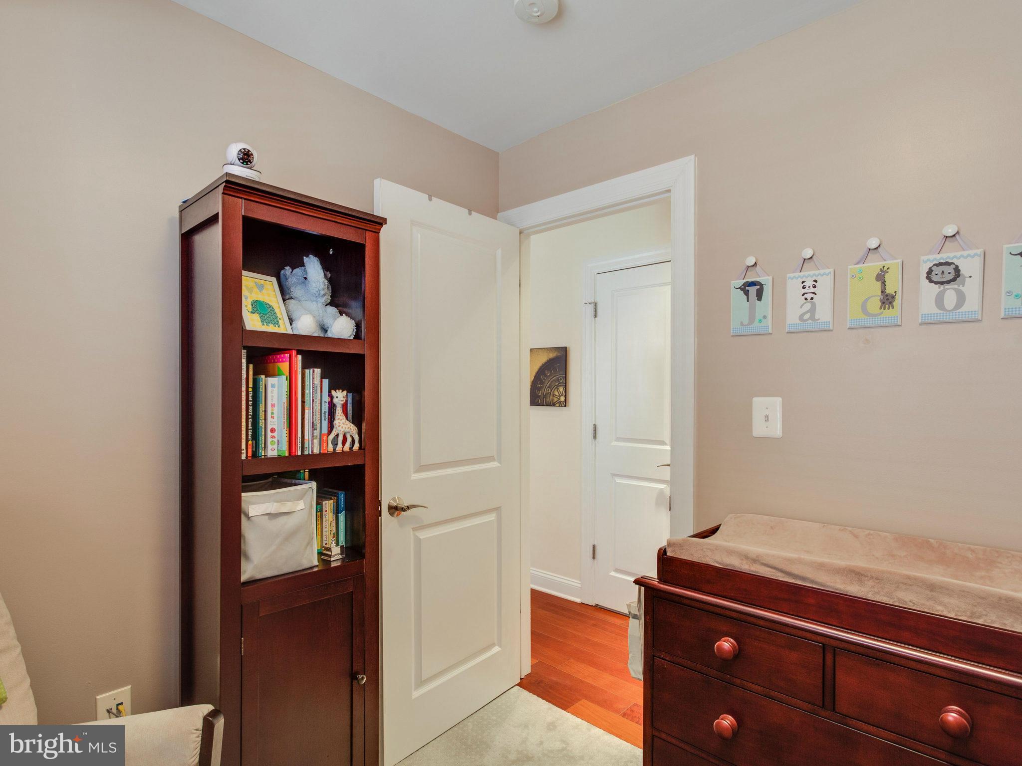 1354 Euclid Street Northwest, Unit B402 Washington, DC 20009 - Photo 18 of 30 a hallway with painting and a book shelf