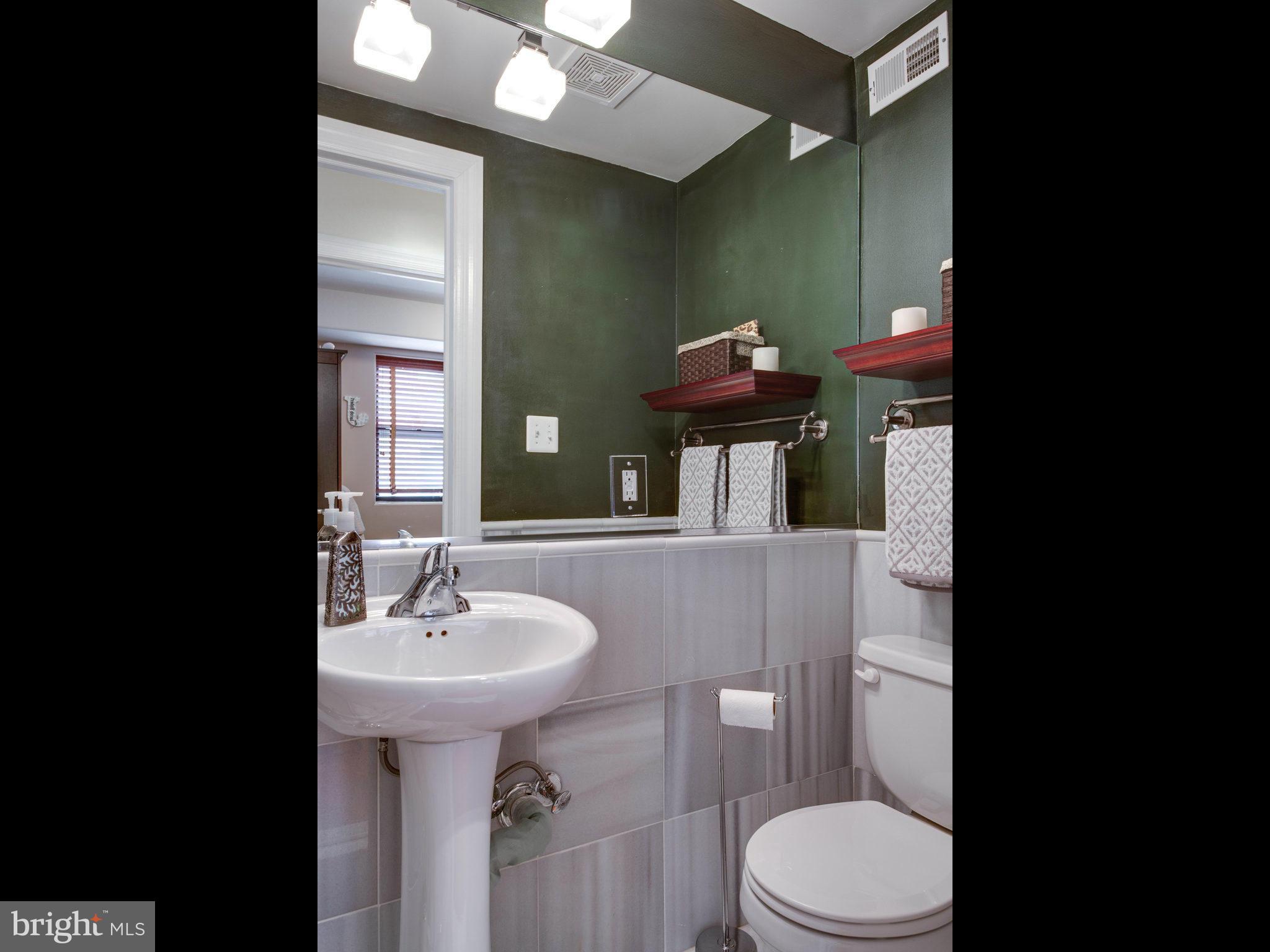 1354 Euclid Street Northwest, Unit B402 Washington, DC 20009 - Photo 19 of 30 a bathroom with a sink toilet and a mirror