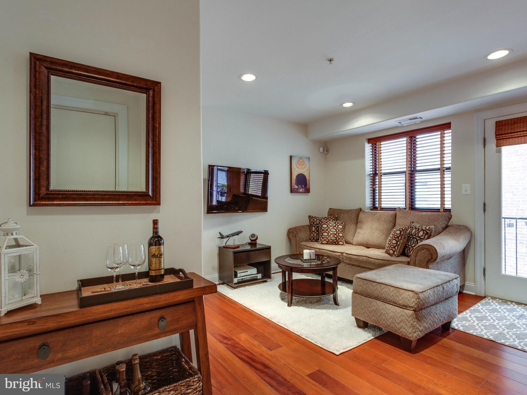 1354 Euclid Street Northwest, Unit B402 Washington, DC 20009 - Photo 4 of 30 a living room with furniture and a flat screen tv