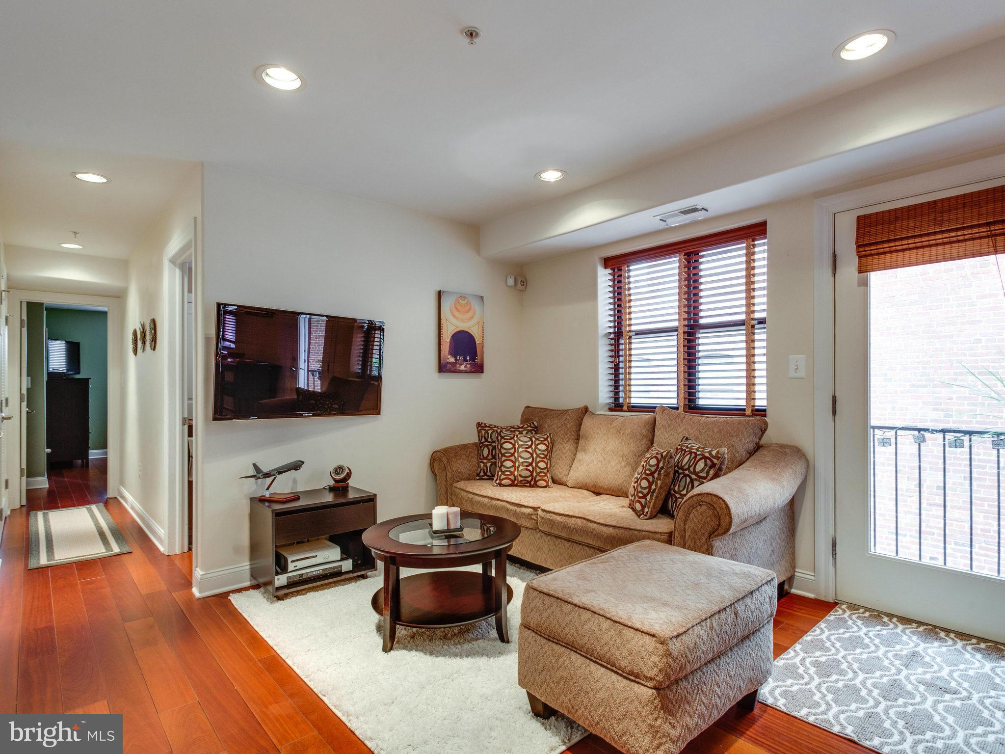 1354 Euclid Street Northwest, Unit B402 Washington, DC 20009 - Photo 6 of 30 a living room with furniture and a flat screen tv