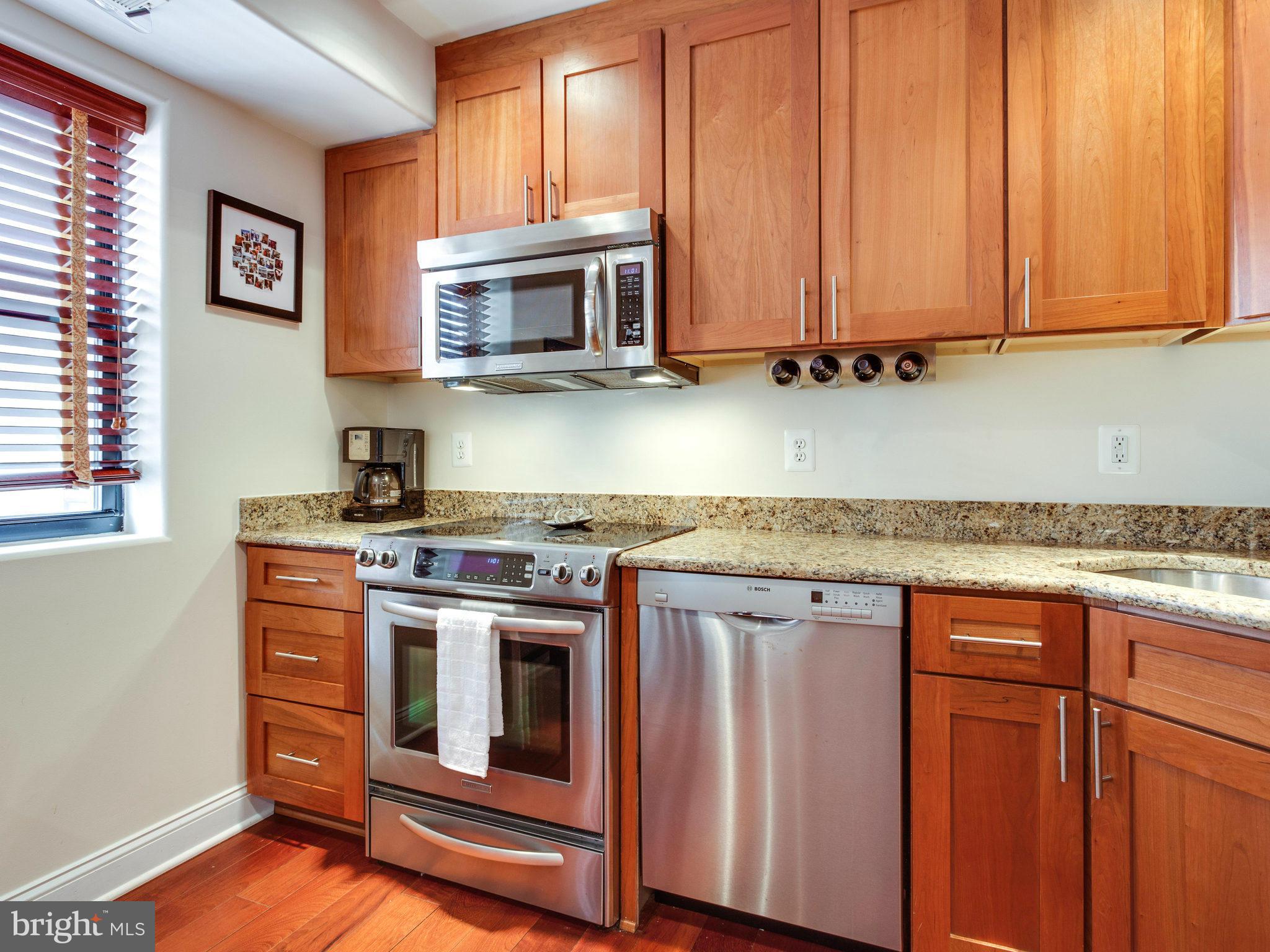 1354 Euclid Street Northwest, Unit B402 Washington, DC 20009 - Photo 9 of 30 a stove top oven sitting inside of a kitchen