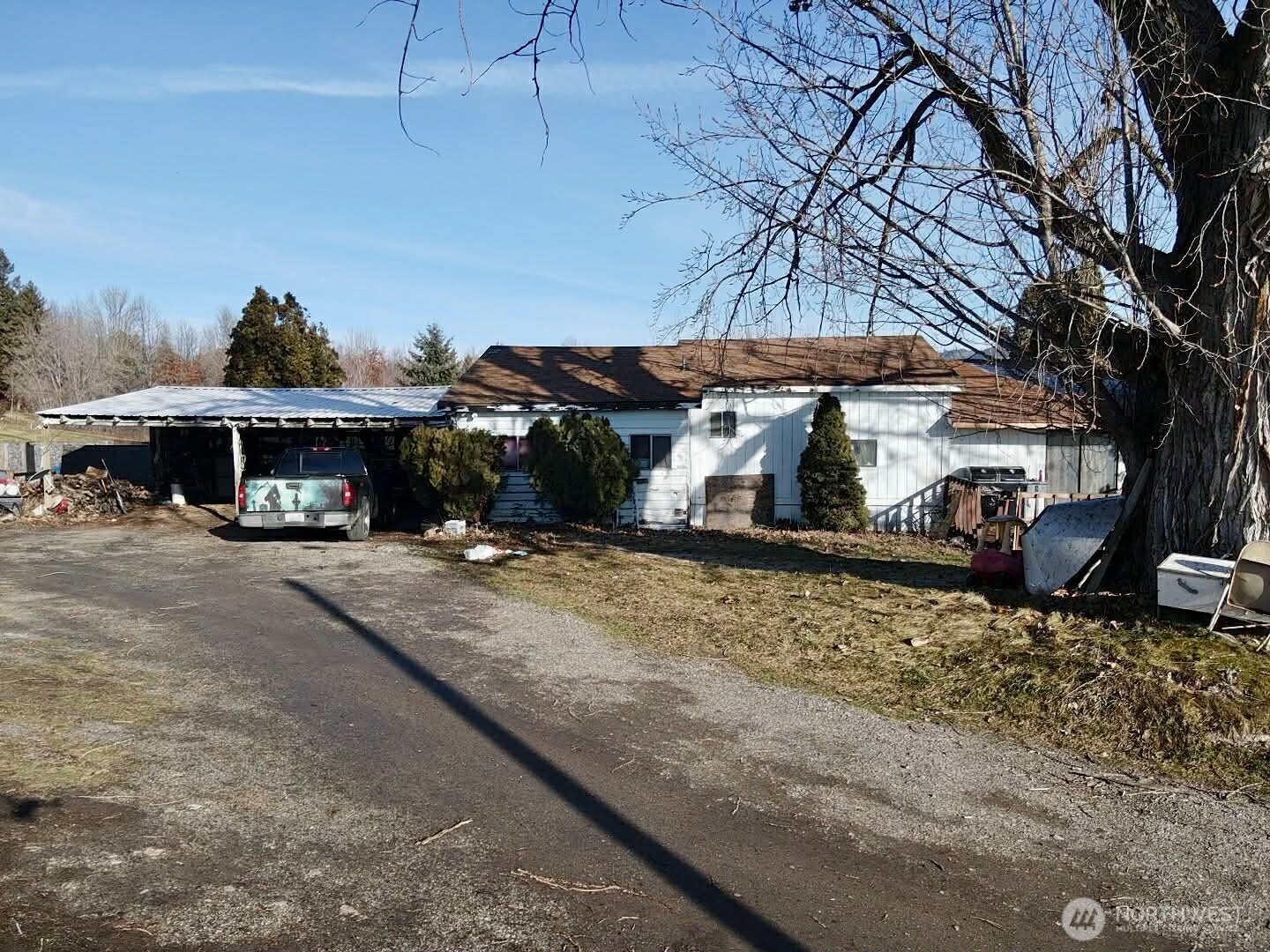 223 Old Riverside Highway Omak, WA 98841 - Photo 13 of 22 a front view of a house with a yard and garage