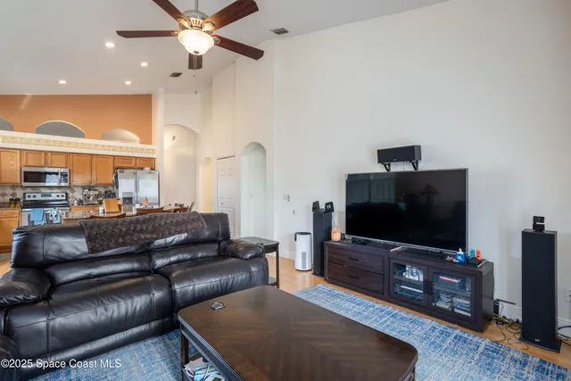 a spacious bedroom with a bed and a flat screen tv