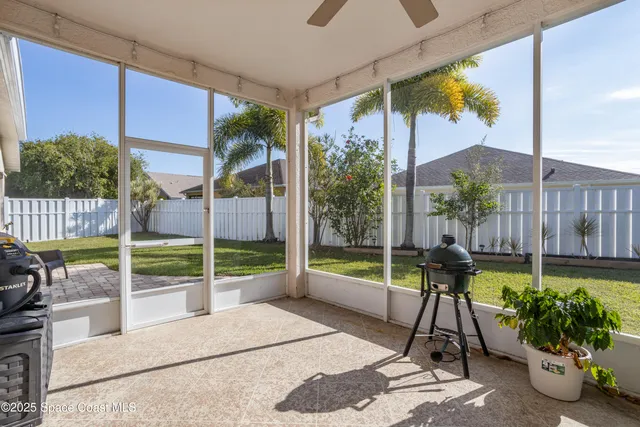 an aerial view of a house with swimming pool and a yard