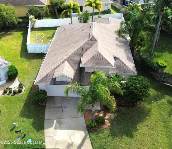 an aerial view of residential house with outdoor space and swimming pool