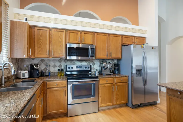a kitchen with granite countertop a sink and a window