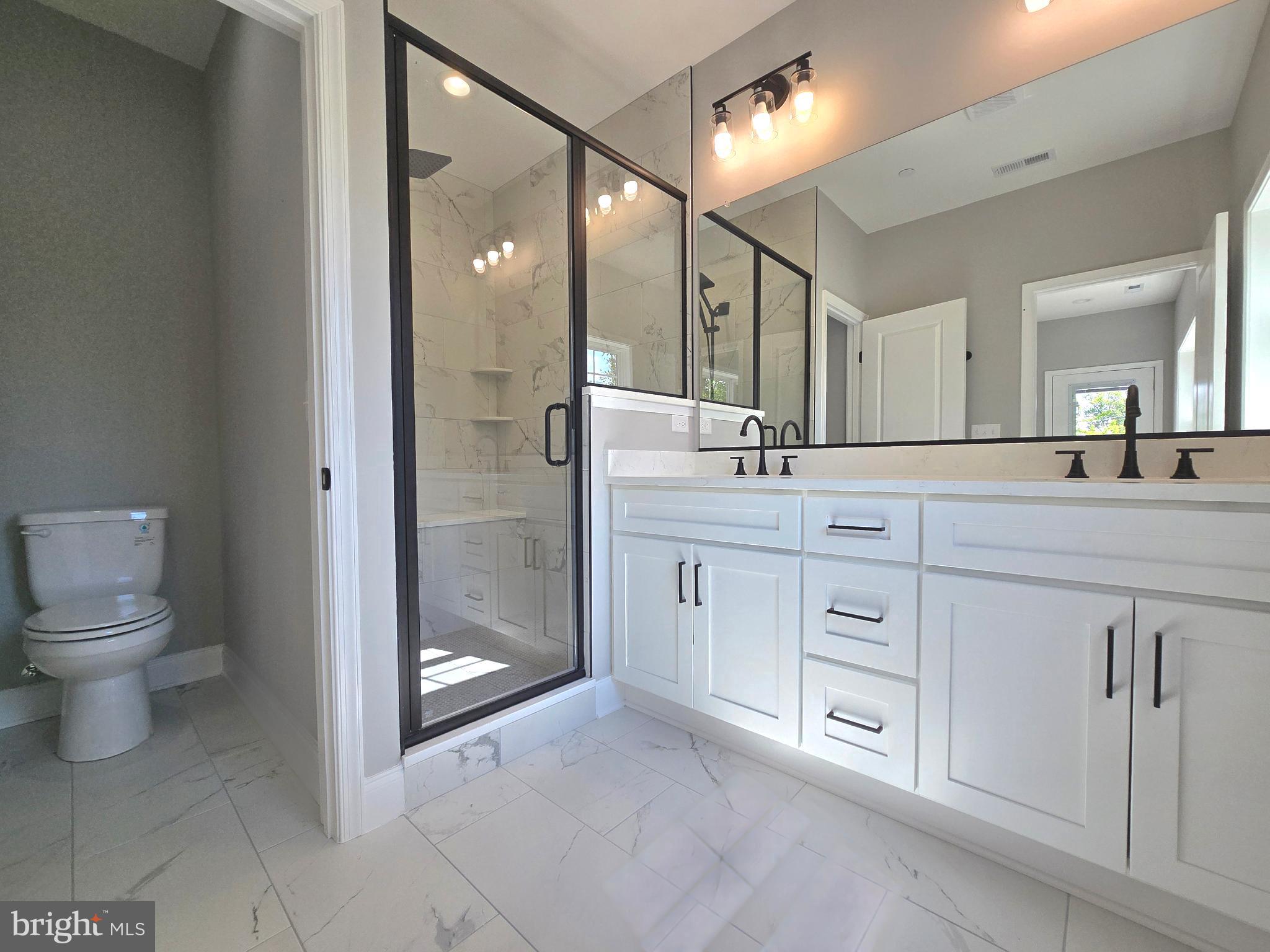 2001 Poplar Ridge Road Pasadena, MD 21122 - Photo 47 of 83 a spacious bathroom with a granite countertop sink mirror and toilet