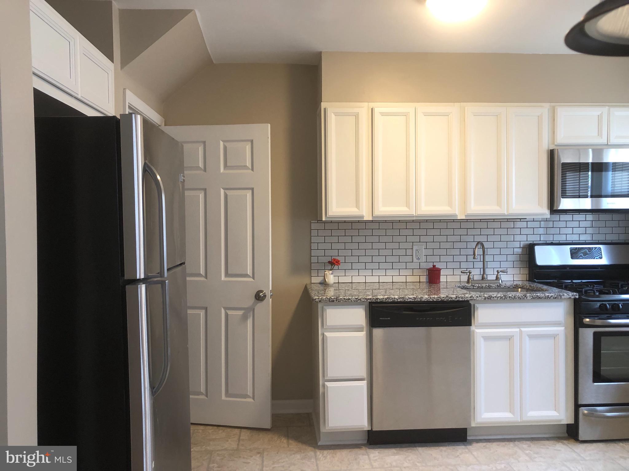 2233 Graythorn Road Middle River, MD 21220 - Photo 32 of 36 a kitchen with white cabinets and refrigerator