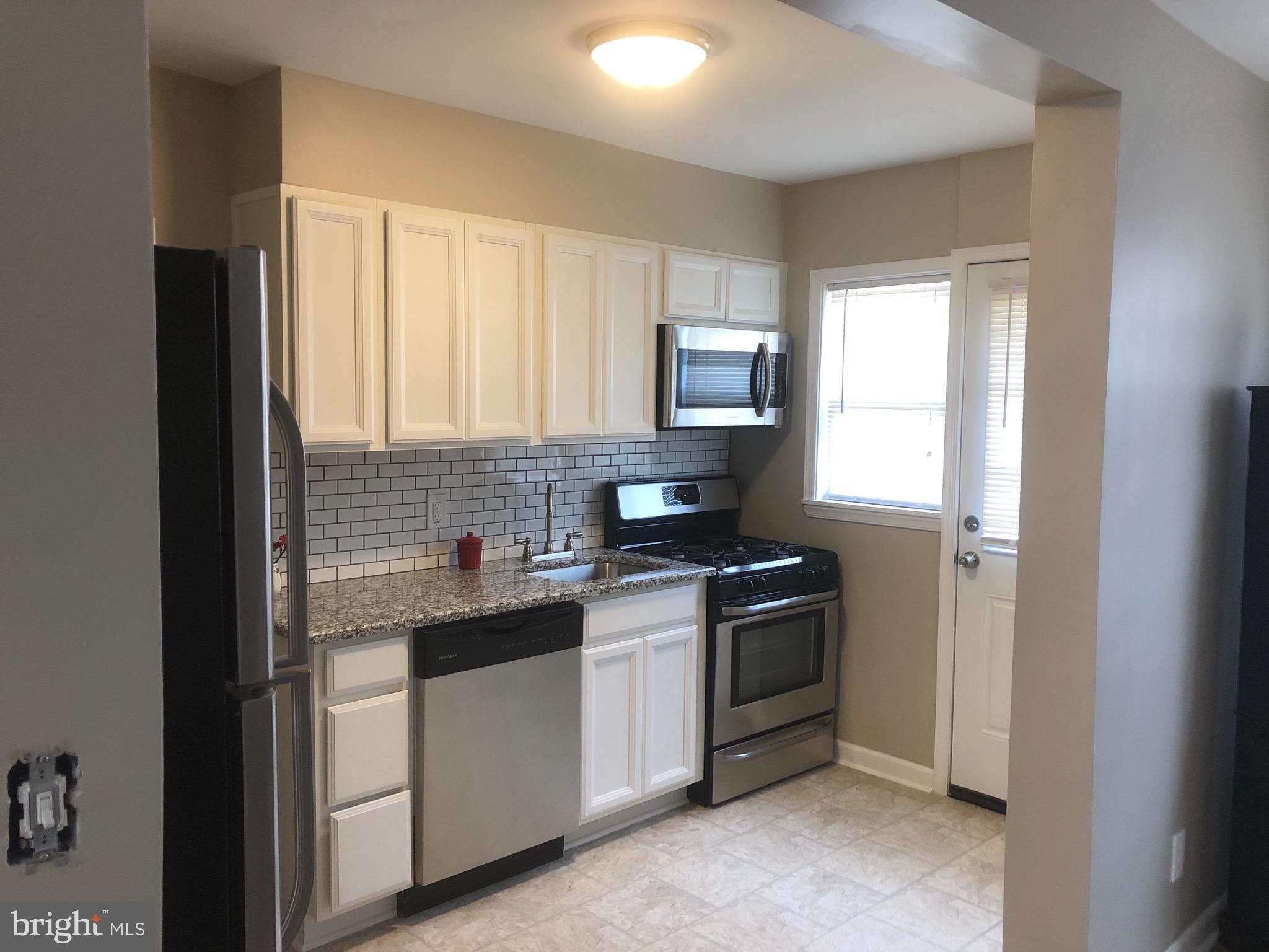 2233 Graythorn Road Middle River, MD 21220 - Photo 5 of 36 a kitchen with stainless steel appliances granite countertop white cabinets stove a sink and dishwasher