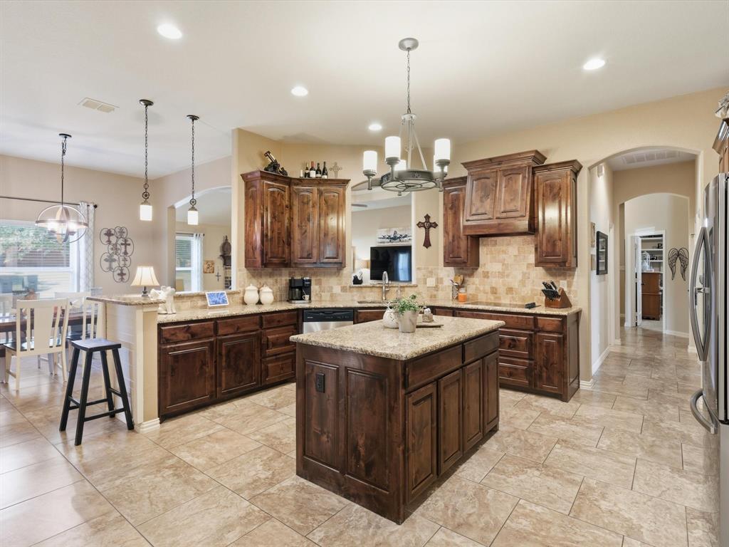 a kitchen with a counter top space appliances and cabinets