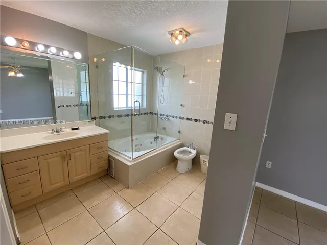 a spacious bathroom with a double vanity sink a mirror and a bathtub