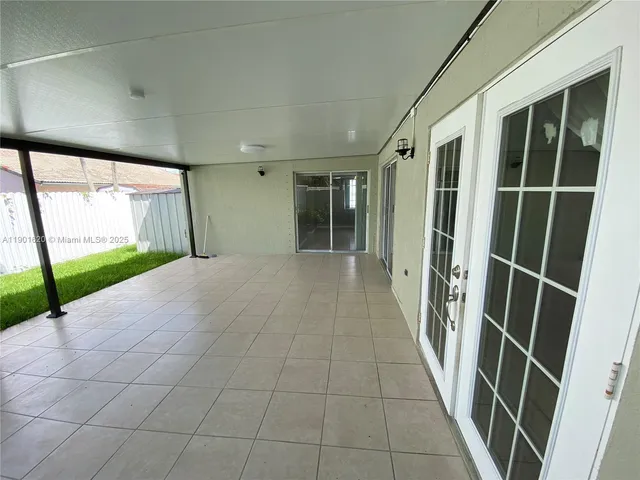 a view of entryway with a floor to ceiling window and stairs