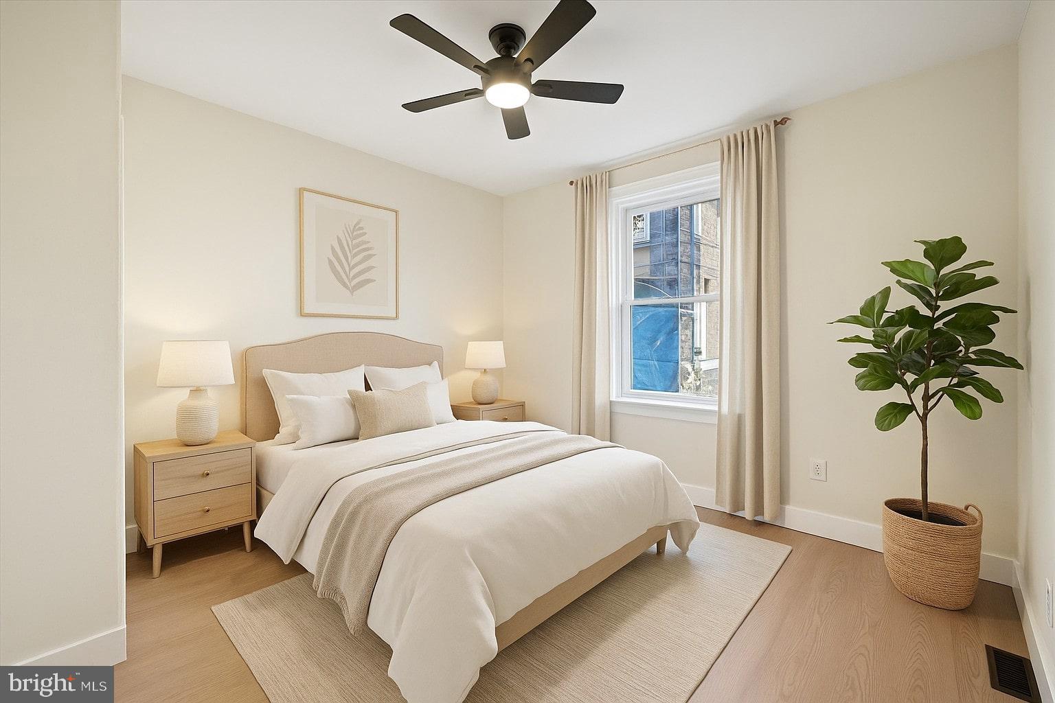 75 High Street Philadelphia, PA 19144 - Photo 11 of 20 a bedroom with a bed and a potted plant