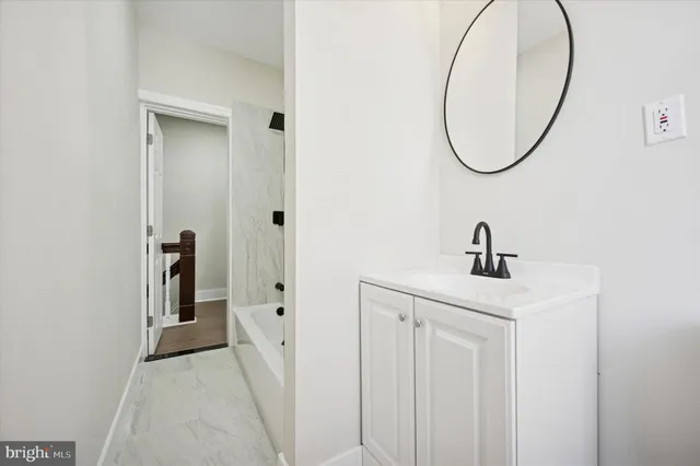 a bathroom with a sink and mirror