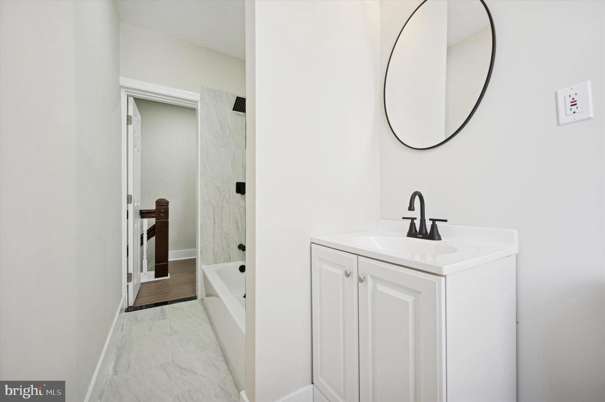 75 High Street Philadelphia, PA 19144 - Photo 13 of 20 a bathroom with a sink and mirror