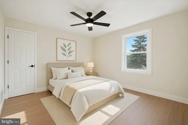 a bedroom with a large bed and a window