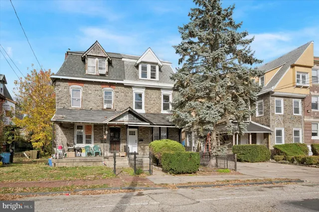 a front view of a residential apartment building with a yard