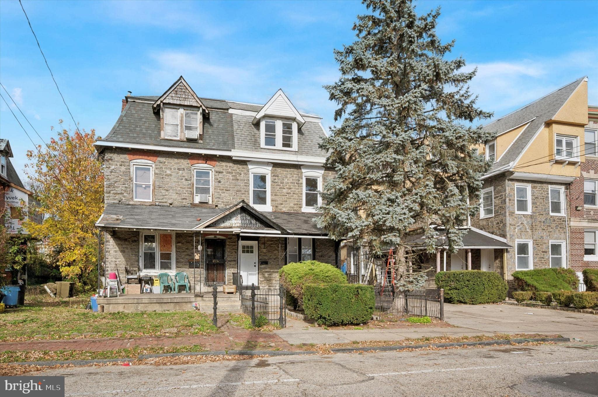 75 High Street Philadelphia, PA 19144 - Photo 19 of 20 a front view of a residential apartment building with a yard