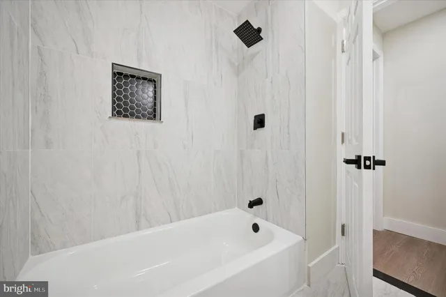 a bathroom with a bathtub and a shower