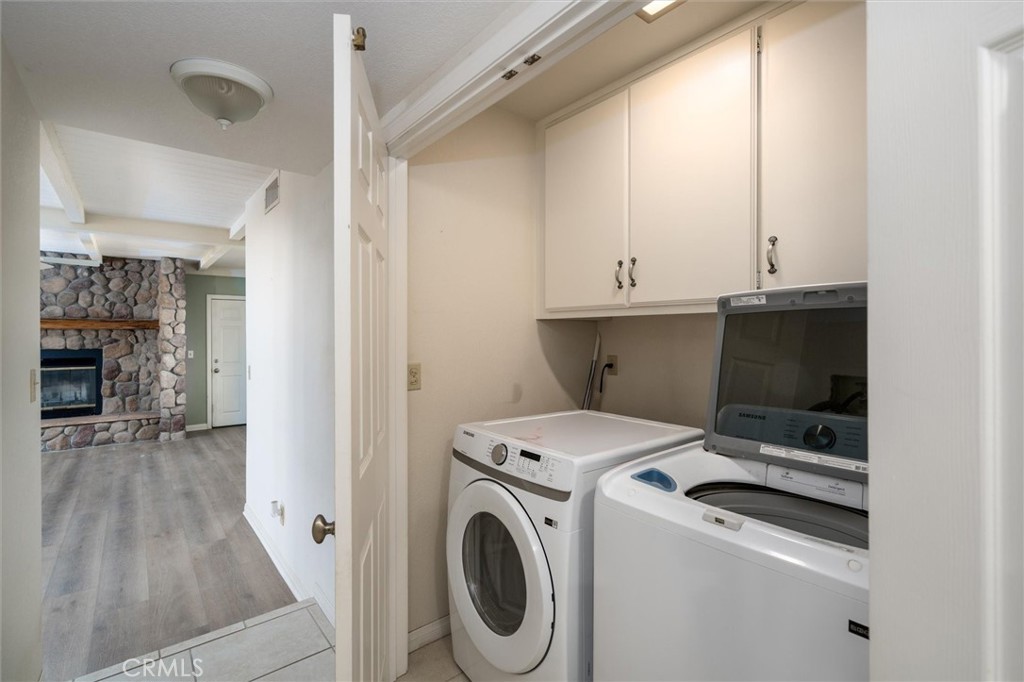 34150 Stowe Road Winchester, CA 92545 - Photo 15 of 80 a view of washer and dryer with kitchen in the background