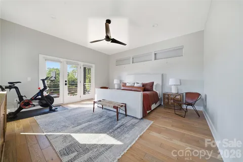 a bedroom with a bed and a chandelier