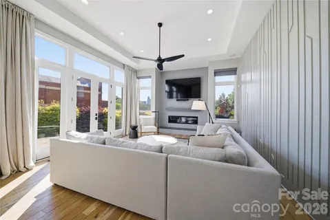 a living room with furniture a rug and a chandelier