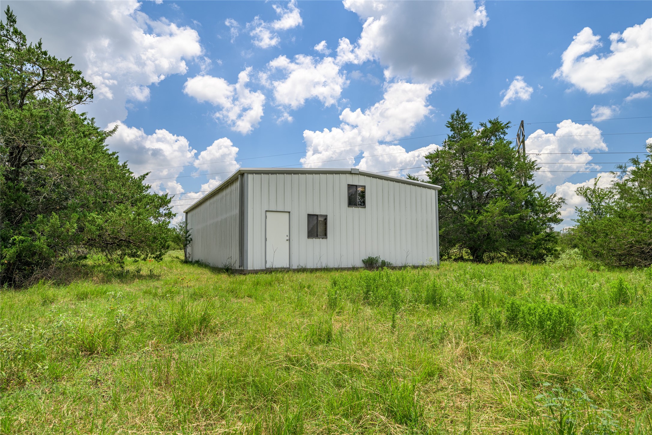 4900 Andreas Road Round Top, TX 78954 - Photo 16 of 20 a backyard of a house with lots of green space