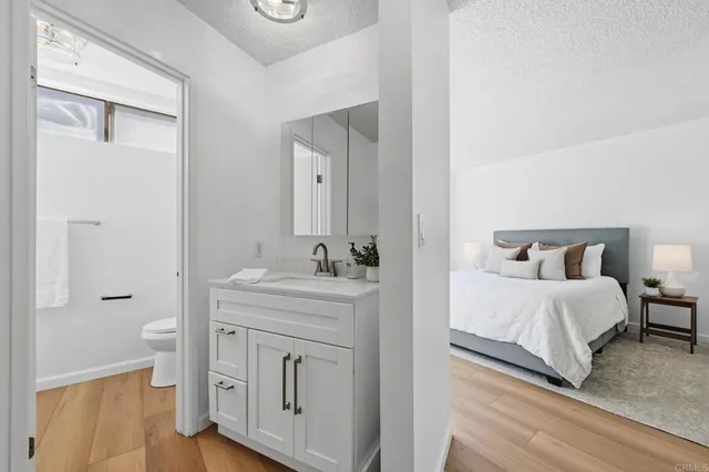 a spacious bathroom with a double vanity sink and mirror