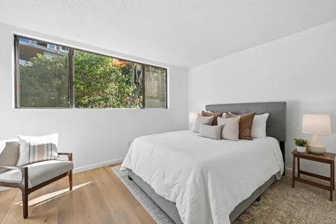 a bedroom with a bed and a couch