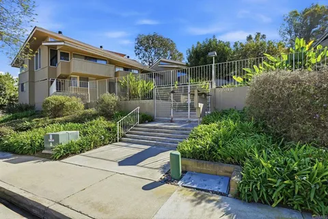 a room with white cabinets and a sink