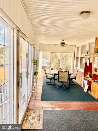a living room with furniture and floor to ceiling windows