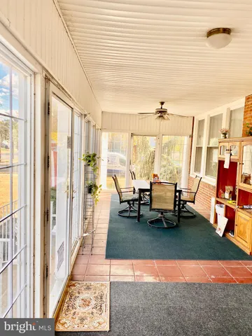 a living room with furniture and floor to ceiling windows