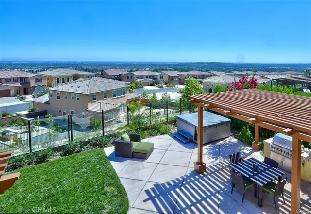 an aerial view of a house with wooden floor outdoor seating and city view