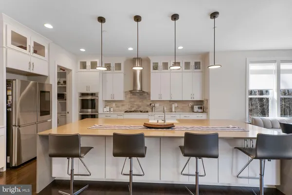 a large kitchen with kitchen island granite countertop lots of counter space and wooden floor