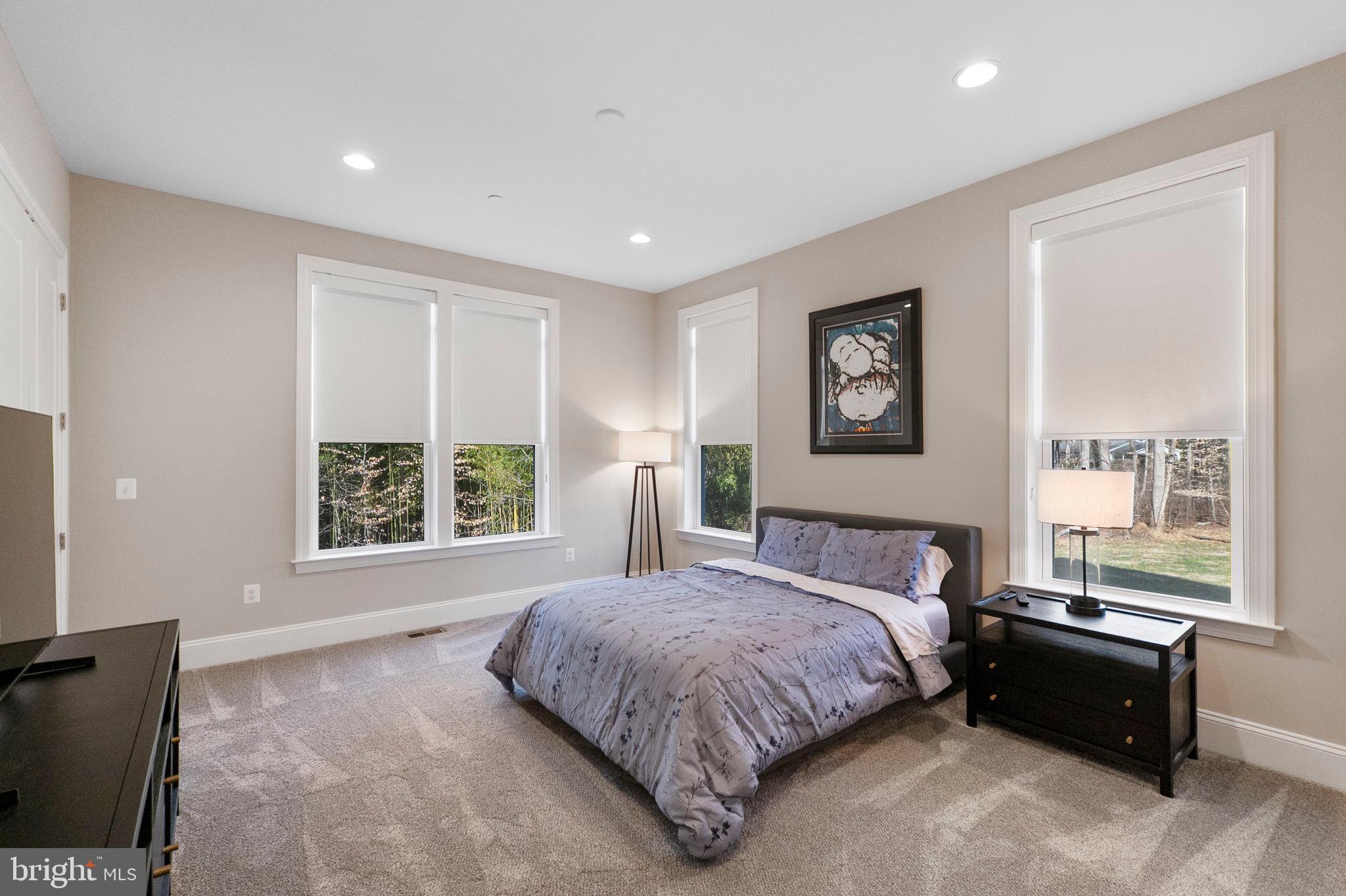 11760 Glen Mill Road Potomac, MD 20854 - Photo 22 of 64 a spacious bedroom with a large bed and a window