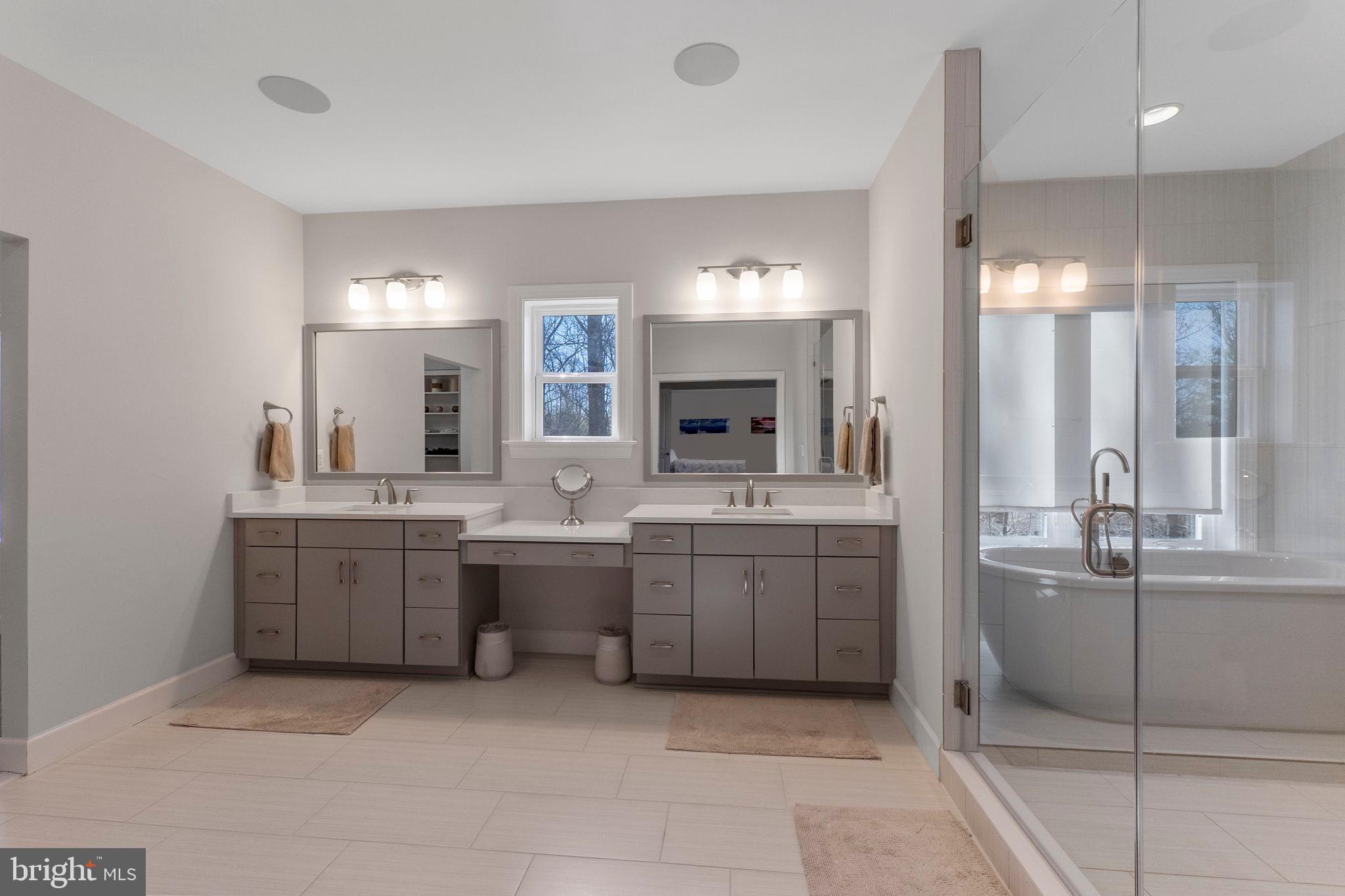 11760 Glen Mill Road Potomac, MD 20854 - Photo 28 of 64 a large bathroom with a large mirror vanity and shower
