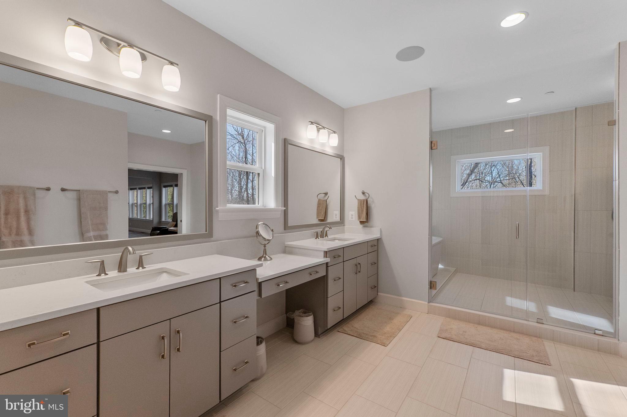 11760 Glen Mill Road Potomac, MD 20854 - Photo 29 of 64 a spacious bathroom with a mirror a double vanity sink and a mirror