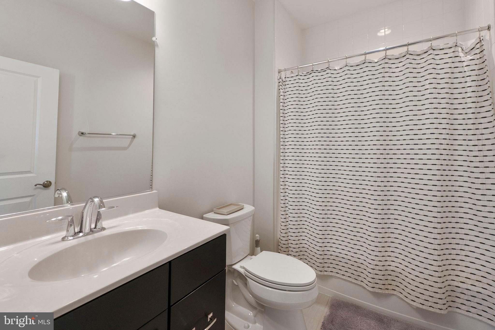 11760 Glen Mill Road Potomac, MD 20854 - Photo 34 of 64 a bathroom with a sink a toilet and mirror