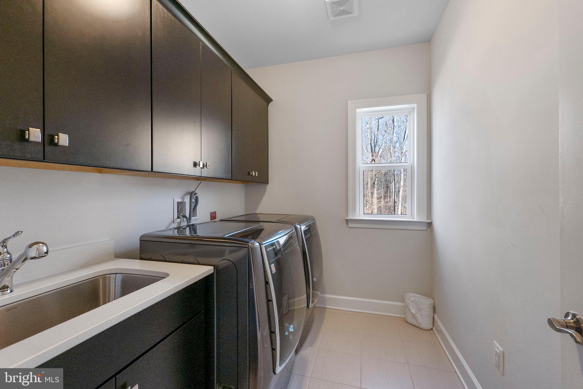 11760 Glen Mill Road Potomac, MD 20854 - Photo 35 of 64 a utility room with sink dryer and washer