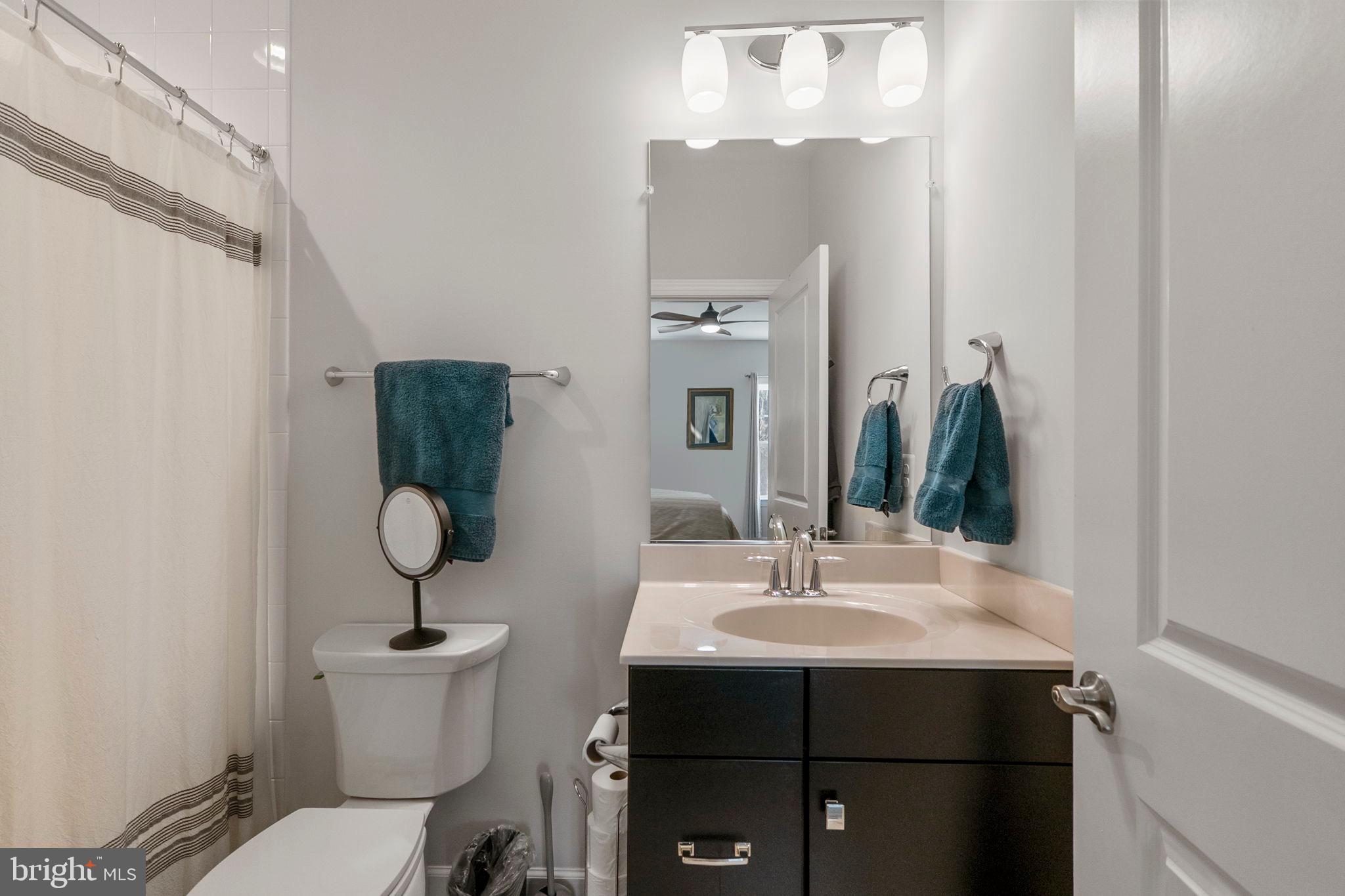 11760 Glen Mill Road Potomac, MD 20854 - Photo 39 of 64 a bathroom with a sink toilet and mirror